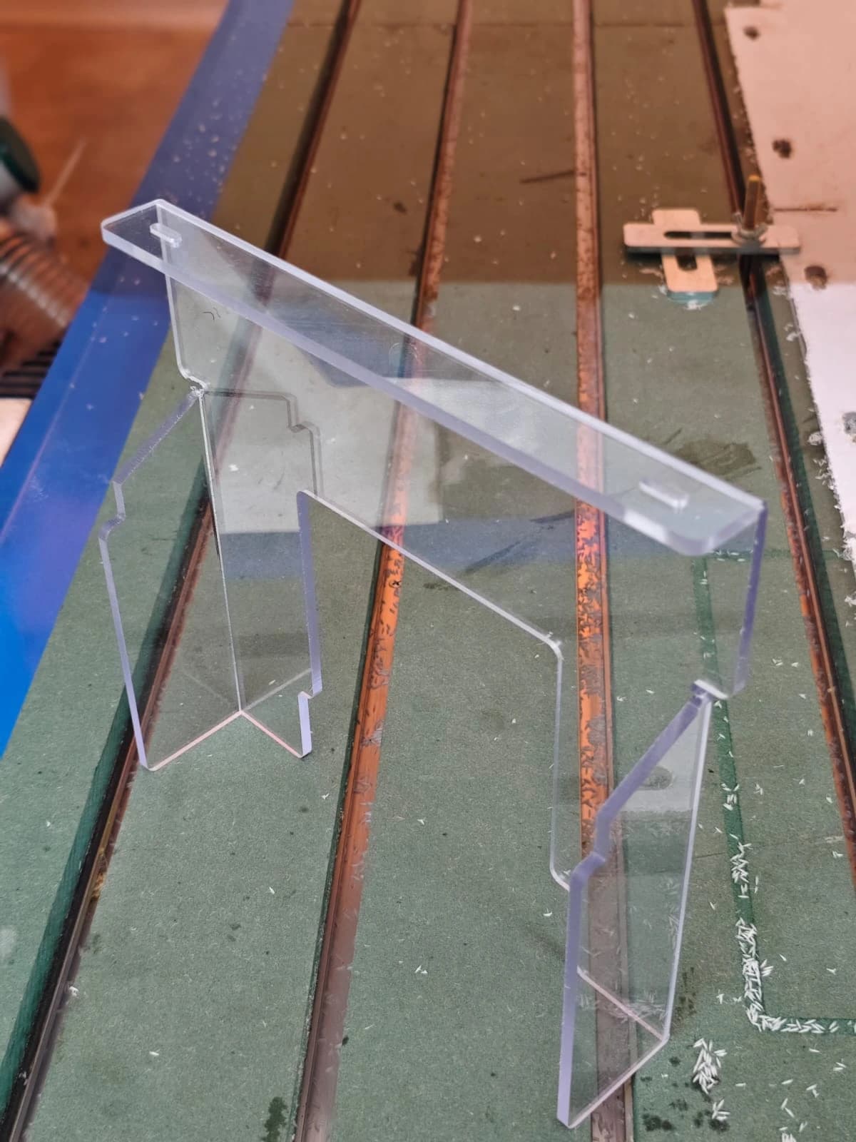 Custom laser-cut clear acrylic display stand fabricated on CNC router machine