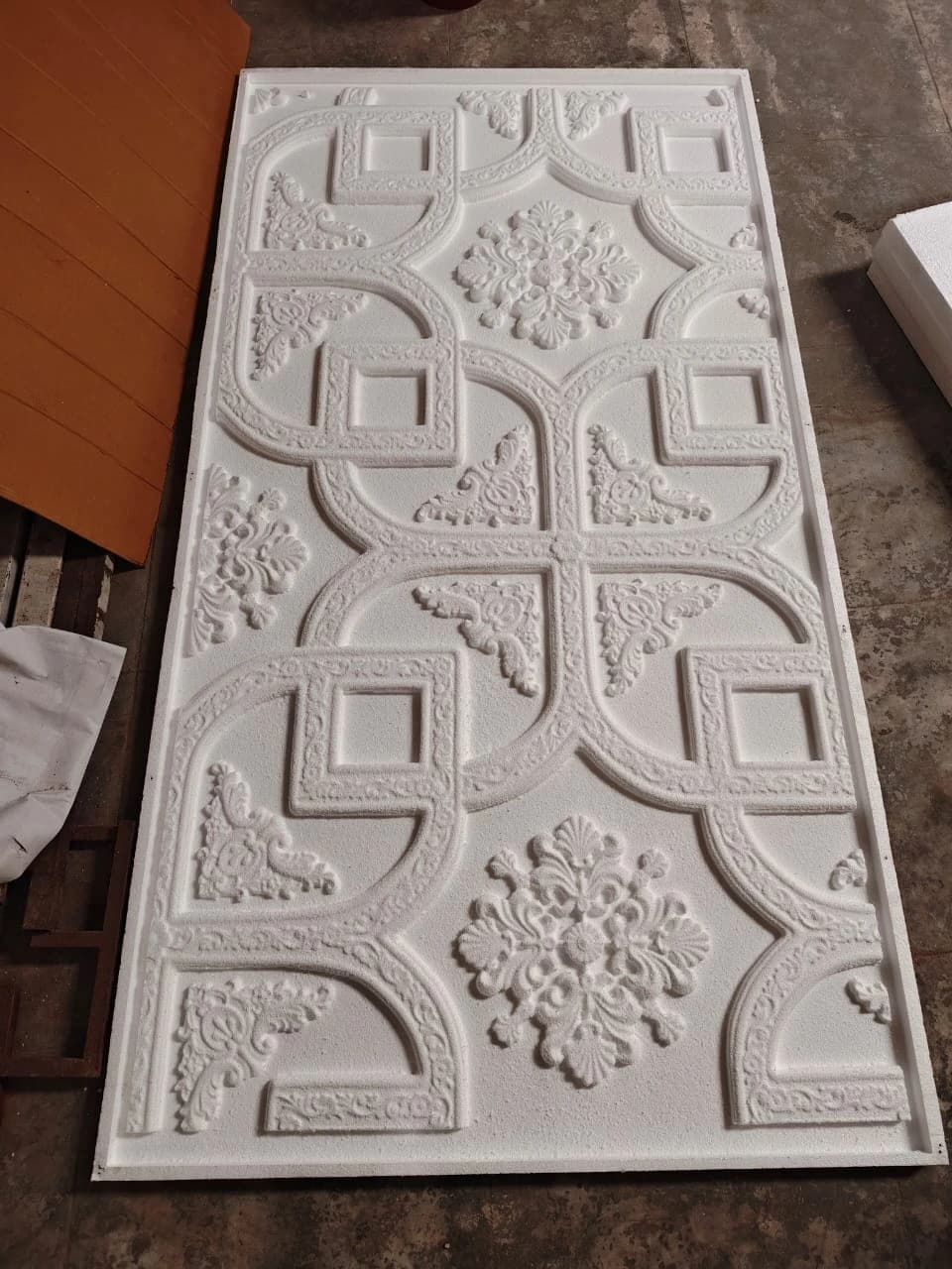 CNC-routed decorative ceiling panel with intricate geometric and floral motifs in thermocol